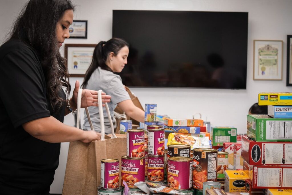 Volunteers packing food in Thanksgiving baskets for Saving Innocence clients